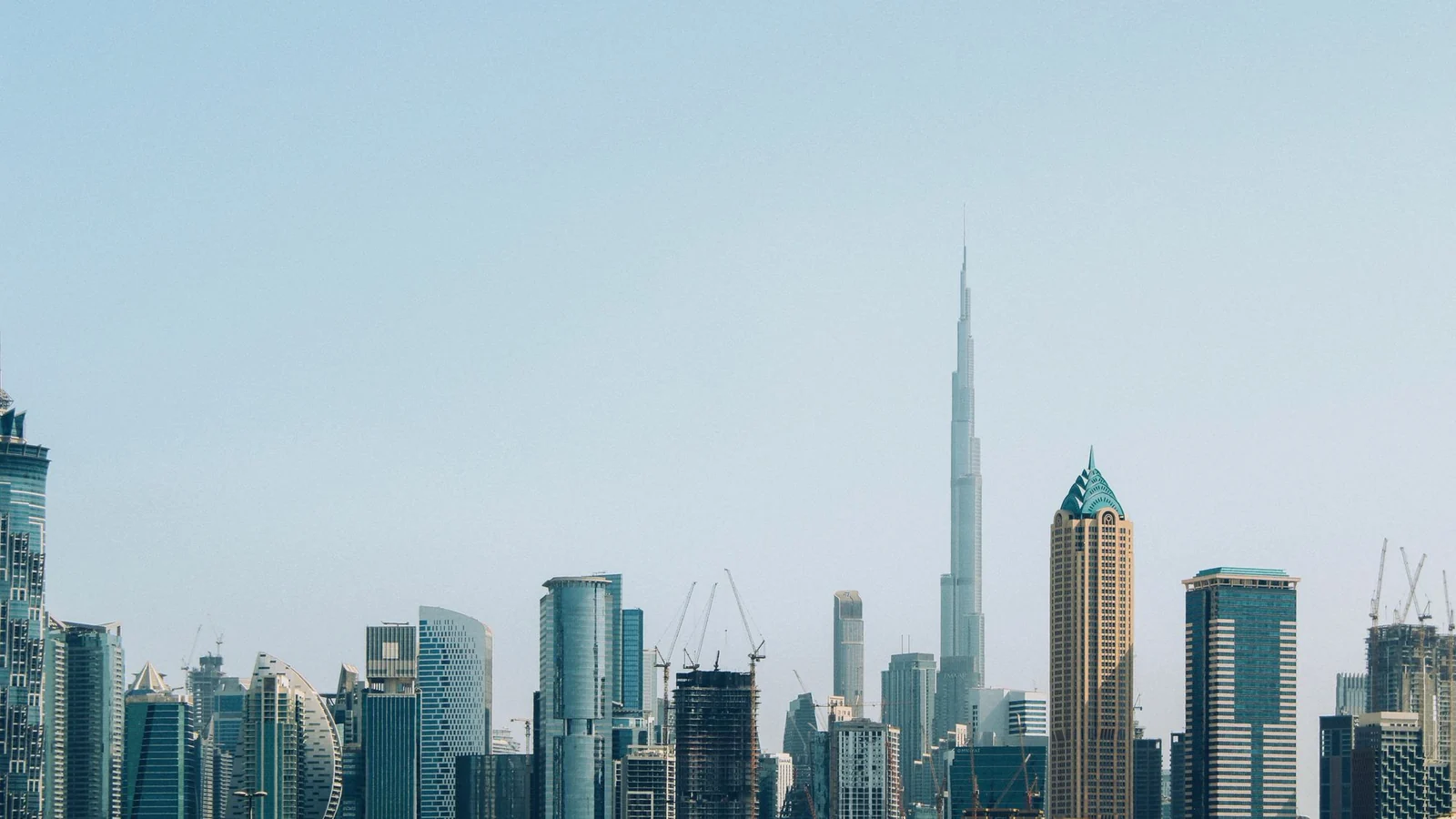Dubai skyline with the Burj Khalifa above a line of towers in daylight
